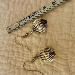 Silver toned ball dangle earrings.